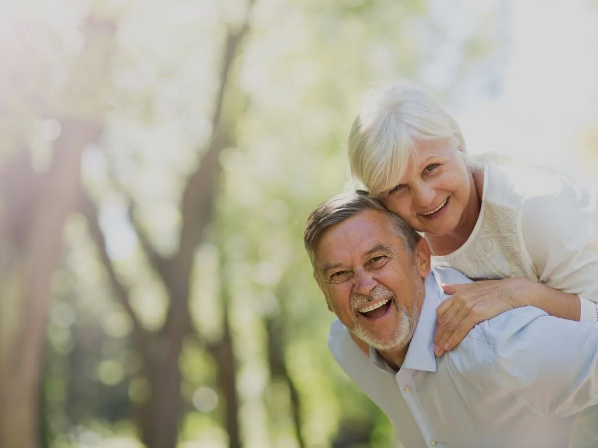 Happy older couple laughing together outdoors