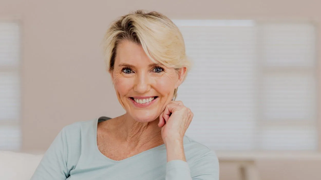 Mature woman smiling confidently at home